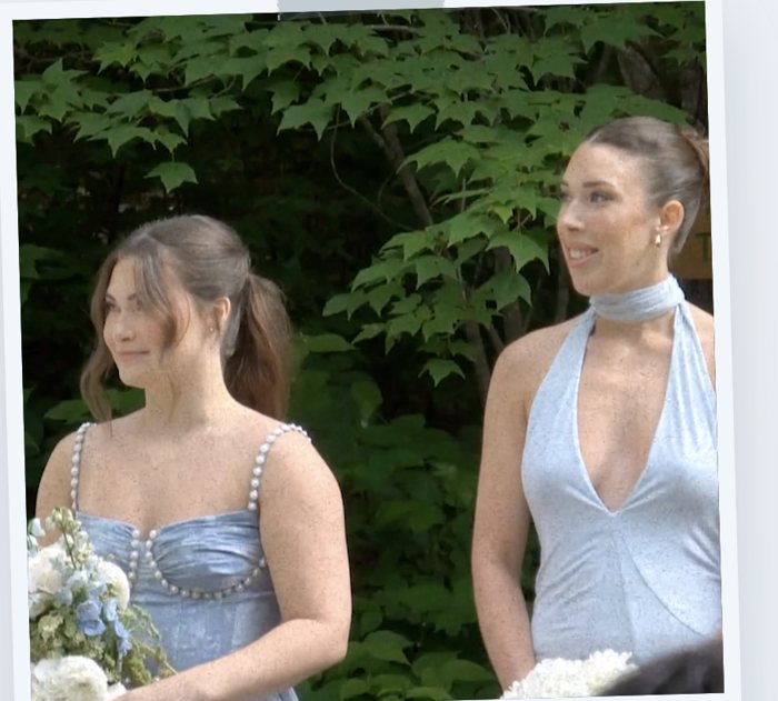 A frame from a Captured by Friends wedding film, two bridesmaids in blue